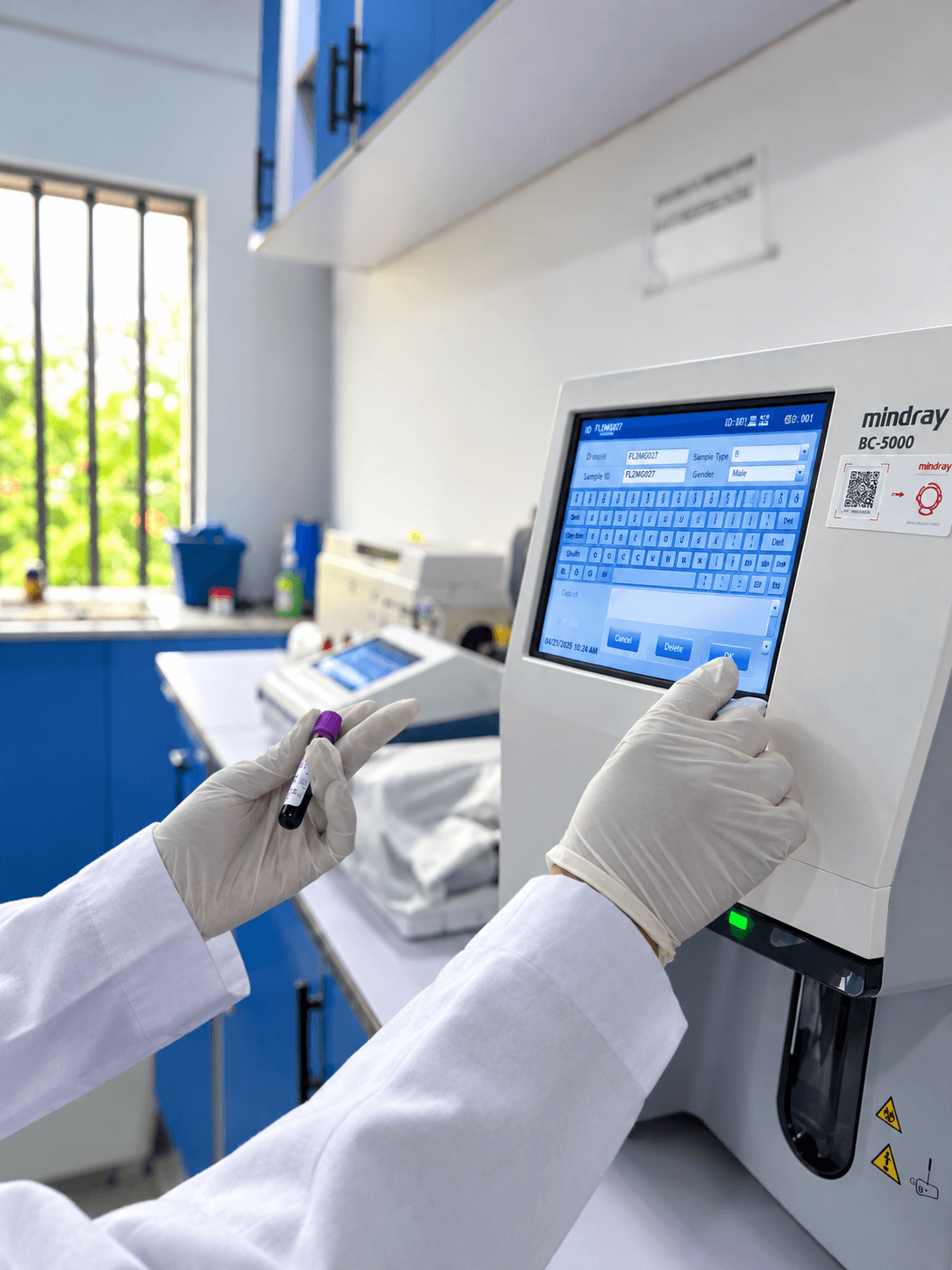 Scientist registering a blood sample on a haematology analyser